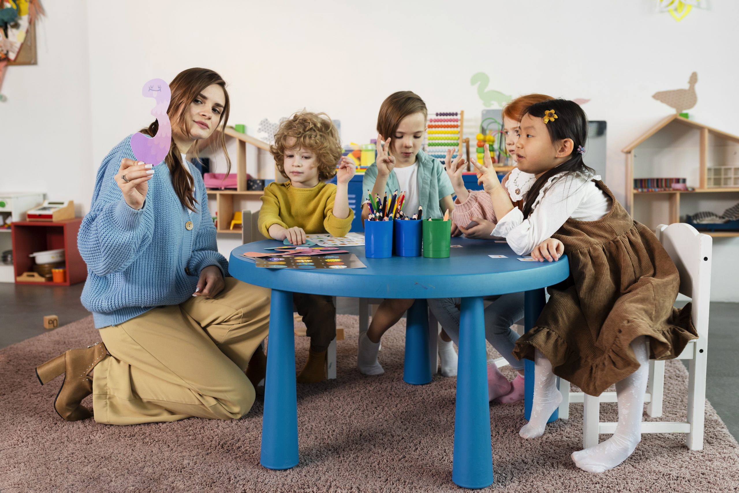 full-shot-kids-sitting-together-table-1-scaled full-shot-kids-sitting-together-table-1-scaled